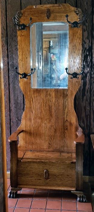 Large Claw Foot Oak and Brass Hall Tree with beveled glass mirror and storage bench.