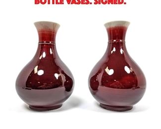 Lot 107 Pair Asian red Flambe Bottle Vases. Signed. 