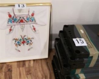 (#13-A) Framed  cross-stitched blouse $15 *** (#15-A) Group of shelving $50