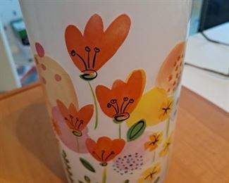 Vase.  It has flowers painted on it so that you will know what it's for.