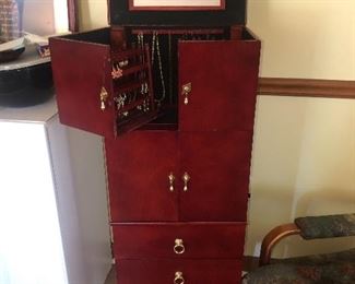 Jewelry armoire filled with costume jewelry 