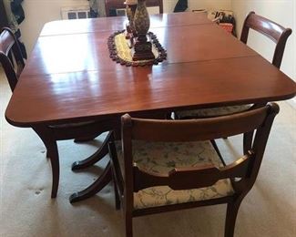 Antique dining room set with matching hutch and four chairs.  Table expands. 