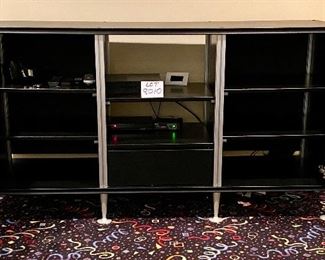 Lot 8010.  $395.00. Very Cool Contemporary Black Media Cabinet  w/ 2 mesh front doors with 3 shelves behind each door, 2 center shelves and 1 drawer.	66" W x 20" D x 36" T