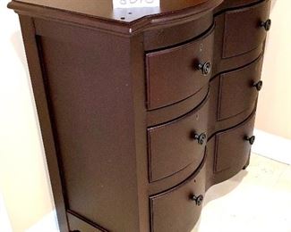 Lot 8018. $225.00.  3 drawer dark brown bedside chest (item number 321-102), top finish is textured to look like leather - great appeal! Owner paid $809.00	34" W x 17" D x 34.5" T