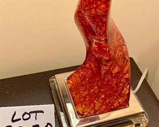 Lot 8020.  $50.00. McCool  orange acrylic/lucite, curved table lamp.  Appears to have a repair but a McCOOL lamp never-the-less.	6" base, shade 7" Diam.