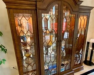 Lot 8024. $1,200.00.  Hooker lighted bookcase/Display/Case with 4 glass doors, 3 glass shelves in each section.  Hooker makes fabulous furniture.  Contents of this cabinet are Not for Sale 	78"W x 84" T x 20" D 