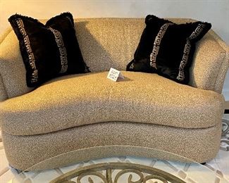 Lot 8025. $700.00.Like New Curved Loveseat made by Precedent Furniture, done in gold tones, includes 2 black/gold Asian inspired pillows. Exc. Condition.	62" W x 40" D x 33" T Homeowner paid over $1,500.00 for this Loveseat. 