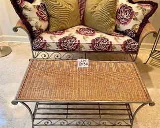 Lot 8034. $850.00. Attractive 8 pc sunroom set in light colored wicker with metal frame and legs.  Very Cute.  The set includes: a Loveseat with rolled arms (57" L); a coffee table with wicker top (32" W);  2 arm chairs 32" W x 34" T); an Ottoman (25" W); a side table, flower stand and magazine rack (22" W) and 8 decorative accent pillows.  This really is a COMPLETE SET, sure to brighten any spot you put it.