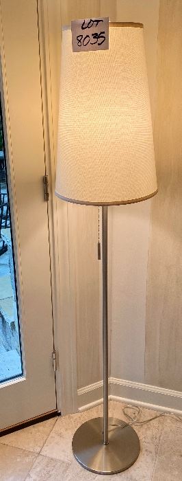 Lot 8035. $65.00  Sleek Brushed nickel floor lamp with cream colored shade and pull chain   61" T x 11" diam base.  