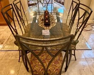 Lot 8041. $1,450.00 Beveled glass top dining table with wrought iron legs and six matching chairs. Our Price is a Steal!  Table: 42" W x 72" L; chairs 20.5" W x 24" D x 42" T  Our homeowner used this set as the Kitchen Dinette Set.  