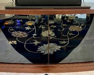 Lot 8062 $575.00 Stunning Corner Media/TV Stand with Premium Wood and Smoked Glass 2 Door Curved Glass Front and 2 Side Storage with Wood Doors.  Glass doors are reflecting the carpet pattern.  	62" W x 22" D x 23" T
