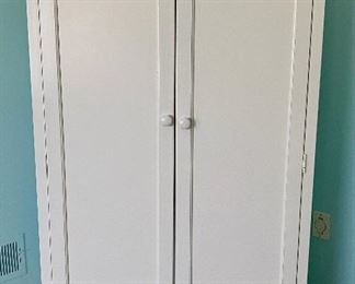 Lot 8092. $325.00  Young America Armoire (Stanley) White with 4 adjustable shelves , with a bar option (shown here for storage), one large drawer on the bottom, a mirror inside one door and a bulletin board on the other door.  Done in White.  Measures 40" w x 23..5" deep and 64" Tall.  Can function as a wardrobe in a room without a closet.	40" w x 23..5" deep and 64" Tall.