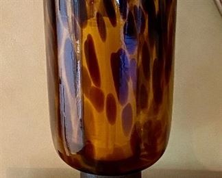 Lot 8103. $25.00. Tortoise design glass hurricane lamp on composite base with battery pillar candle.  19" T  x 8" Diam.   This lamp casts a beautiful glow when candle is turned on!  Super special!