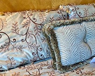 Lot 8109. $42.00. Three Decorator Pillows - Two are brown and taupe fringed pillows (34" W x 16" T) and one is a double fringed teal and gold  28" W x 14" T designer fabric