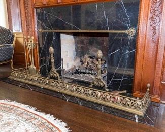 A Continental Brass Fireplace Fender, Andirons and Tools. Probably First Quarter of the Twentieth Century. No Marks Evident.   The brass fireplace suite comprising a fender with pierced scroll decoration, 2 andirons having acorn shaped finials overturned standards ending on arched feet and 3 fire utensils with stand.
Dimensions: Height of andirons 24 inches.   $1,000.00
