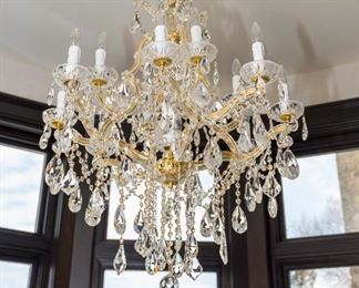 A Baccarat Style Leaded Glass and Brass Twelve Light Chandelier. Circa 2010-2013.

 The chandelier in the Baccarat style having 12 electrified lights with clear glass swag tubes over brass tubing and multiple drops and swag jewels.

Dimensions: Height 36 x width 32 inches.	 $2,500.00
