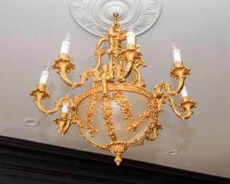 A Restauration Style Gilt Metal and Glass Eight Candle Chandelier. Circa 2010-2013. No Marks Evident.
The chandelier in the Restauration style having git metal surface overall with eight electrified candles set on scrolled arms, the arms emanating from the convex glass bowl set in floral, foliate and ribbon swag.
Dimensions: Height 36 x width 32 inches approximately.   $3,000.00
