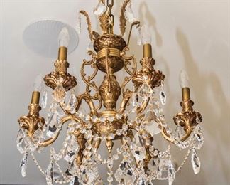 A Brass and Leaded Glass Baccarat Style Six Light Chandelier. Circa 2010-2013. 
The chandelier having a brass superstructure with scrolled arms and six electrified candles with leaded glass drops and jewel swags.
Condition: Very Good.
Dimensions: Height 29 x width 21 inches approximately.   $600.00
