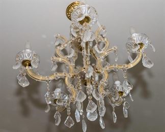 A Group of Six Venetian Style Leaded Glass and Brass Six Light Accented Chandeliers. Possibly Swarovski.  Circa 2010-2013.
The group of 6 chandeliers in the Venetian style and likely manufactured by Swarovski each with clear glass scrolled arms around brass tubing having six electrified candles and with multiple leaded glass drops. 
Condition of Group: Very Good.
Dimensions: height 25 x width 30 approximately.	For Six:   $4,800.00  Each $800.00
