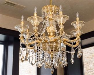 A Gilt Metal and Leaded Glass Eight Light Chandelier. Circa 2010-2013.
The chandelier of gilt metal composition having 8 electrified candles with clear glass bobeches and leaded glass swags and drops.
Condition: Very Good.
Dimensions: Height 30 x width 26 approximately. $2,000.00