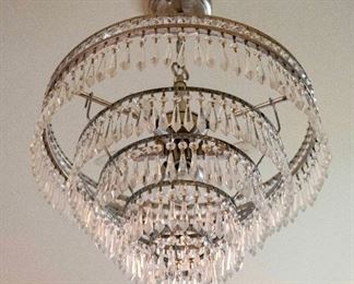 A Contemporary Five-Tiered Nickle and Leaded Glass Chandelier. Circa 2010-2013.
The chandelier of plated nickel composition with five concentric graduated tiers having multiple prisms.
Condition: Very Good.
Dimensions: Height 16 x width 22 inches approximately. $500.00