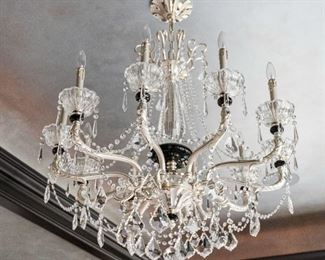A Baccarat Style Silver Gilt and Leaded Glass Ten Light Chandelier. Circa 2010-2013.
The chandelier in the Baccarat style having clear glass with colored glass accents, the scrolling arms with 10 electrified candles and supporting multiple jewel swags and drop
Dimensions: Height 39 x width 36 inches. $2,500.00