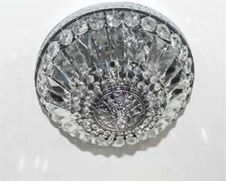 Two White Metal Mirrored and Leaded Glass Diminutive Chandeliers. Circa 2010-2013.
Dimensions: Height 11 x width 14 inches approximately. For Two: 250.00
