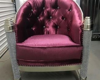 A Pair of red satin and silvered chairs in the East Indian taste having a concave back with tufted crystal buttons, raised on conical legs with applied crystals. No Manufacturer's Marks. Circa 2013.
Dimensions: Height 38 x width 32 x depth 24 inches. For the pair $2,200.00