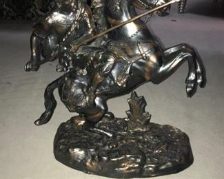 A Patinated metal sculpture of a Medieval knight on horse back. No Marks Evident. Height 18 x width 17 x depth 7 inches. $150.00