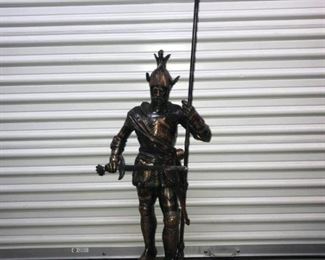 A Patinated metal sculpture in the form of a Medieval knight in armor with halberd. No Marks Evident. Height 50 inches to tip of halberd. $225.00