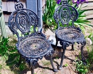 2 of 3 black iron chairs