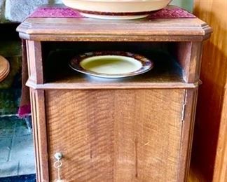 Antique wooden cabinet, pottery plates, bowl