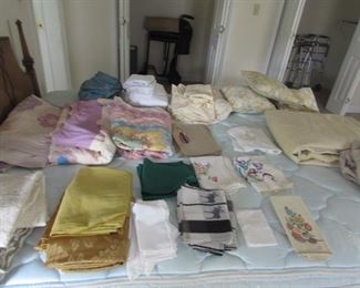Table clothes, napkins, old quilts and quilt tops, sheets, full and queen, embroidered items, gold tone queen/king size bedspread