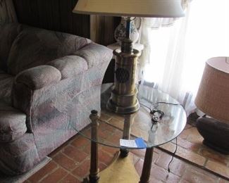 Glass top table, nautical brass lamp with flickering flame base.