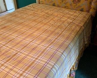 Plaid bedspread; yellow tufted headboard
