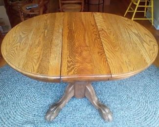 3' Round oak claw foot table w/ 2 leaves. No chairs