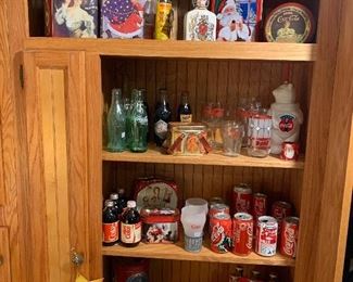 Large assortment of Coca-Cola collectibles, including diecast delivery truck, antique bottles, drinking glasses, and assortment of bottles and cans