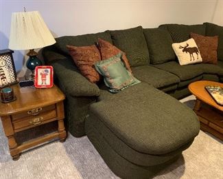 Would end table, green lamp, very comfortable green sectional sofa, assortment of throw pillows