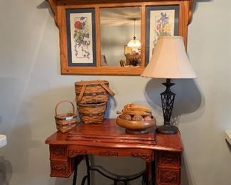Antiqued Treadle sewing machine cabinet, no machine, Longaberger  baskets, mid century carved wood fruit and bowl, rot iron lamp, and Minnie home accessories