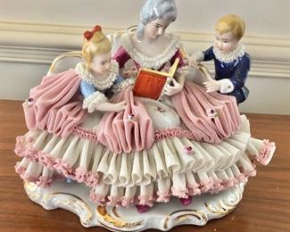 $150 - Porcelain woman reading to her children.   7.5" H, 9" W, 6.5" D.
