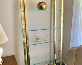$375 each - Brass and glass lighted etagere (2 available).  78" H, 34" W, 13" D. 