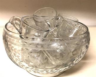 $45 Glass punchbowl with 15 cups (various patterns). Punchbowl: 6" H, 10.5" diam. Cups: 3" H, 3" diam.