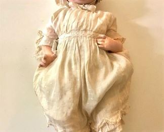 $450 .   Bisque doll in original clothing 18" L. 