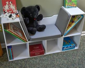 child's reading bench with cubbies, children's books, games