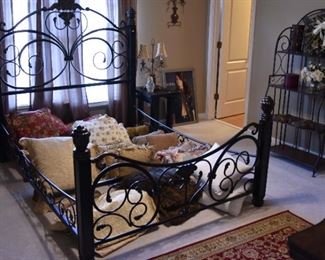 metal bed, pillows, shelved stand