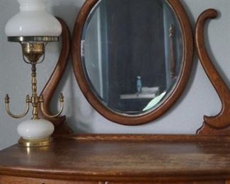 Oak dresser with mirror 72 in tall 31 in in length 19 in deep with brass electrified lamp