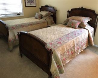 Antique twin bed frames and mattress sets - beautiful bedspreads with matching shams.
