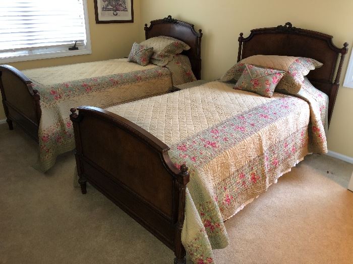 Antique twin bed frames and mattress sets - beautiful bedspreads with matching shams.