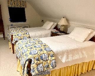 Antique twin tie beds with custom bedding
