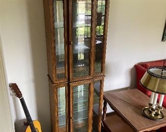 Acoustic guitar and curio cabinet 